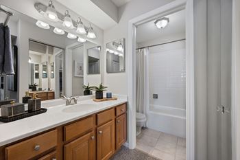 New designer baths with maple cabinetry, marble vanity tops, and brushed nickel fixtures